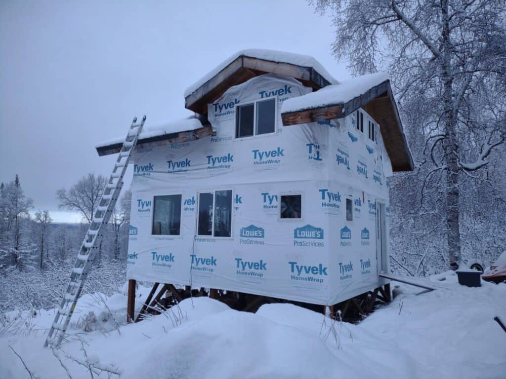 cabin being built in alaska winter